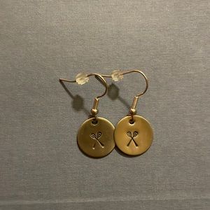 Never worn earrings with lacrosse stick design